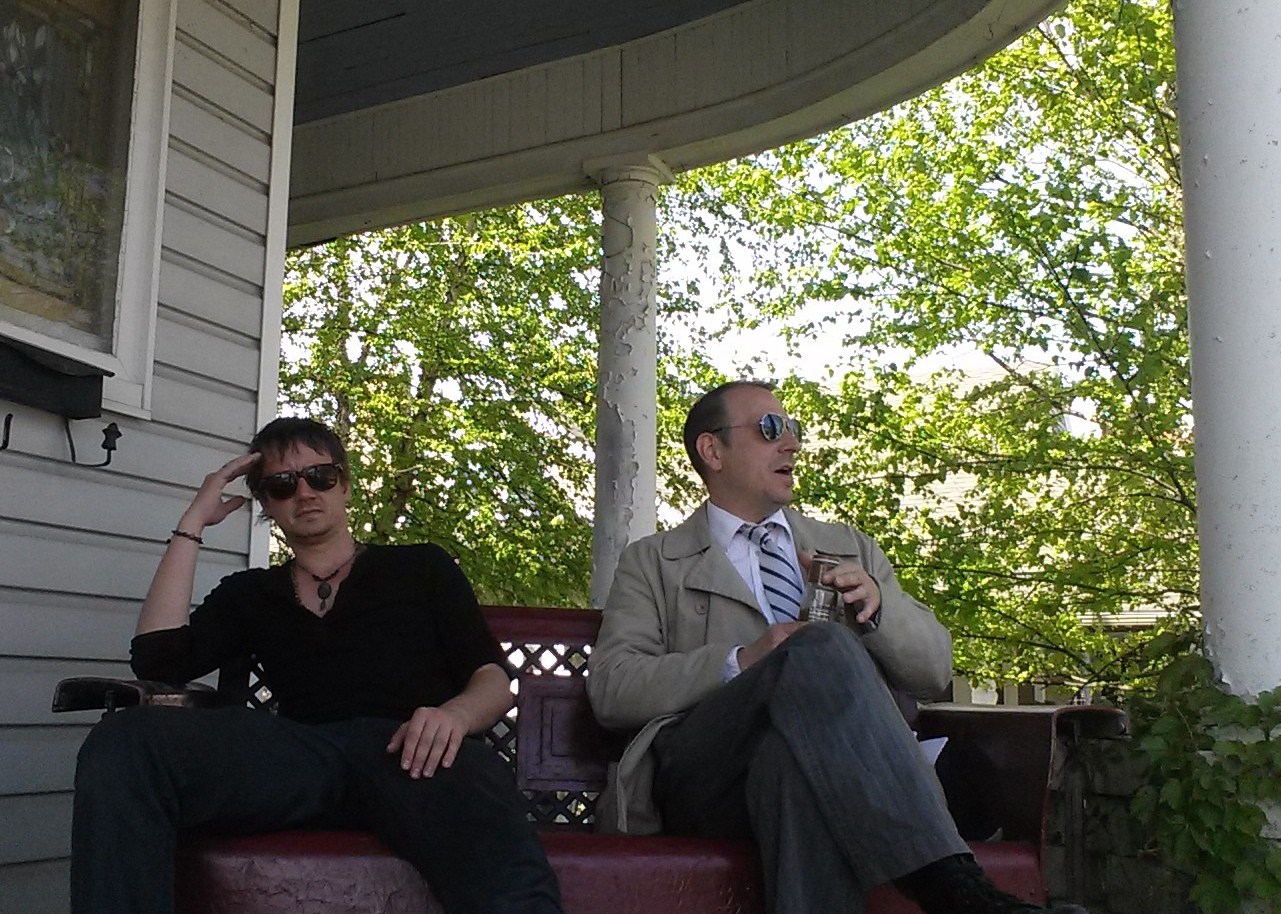 Chad Lindberg (left) and a Frapuccino-drinking John E.L. Tenney relaxing on the porch of Whispers Estate.