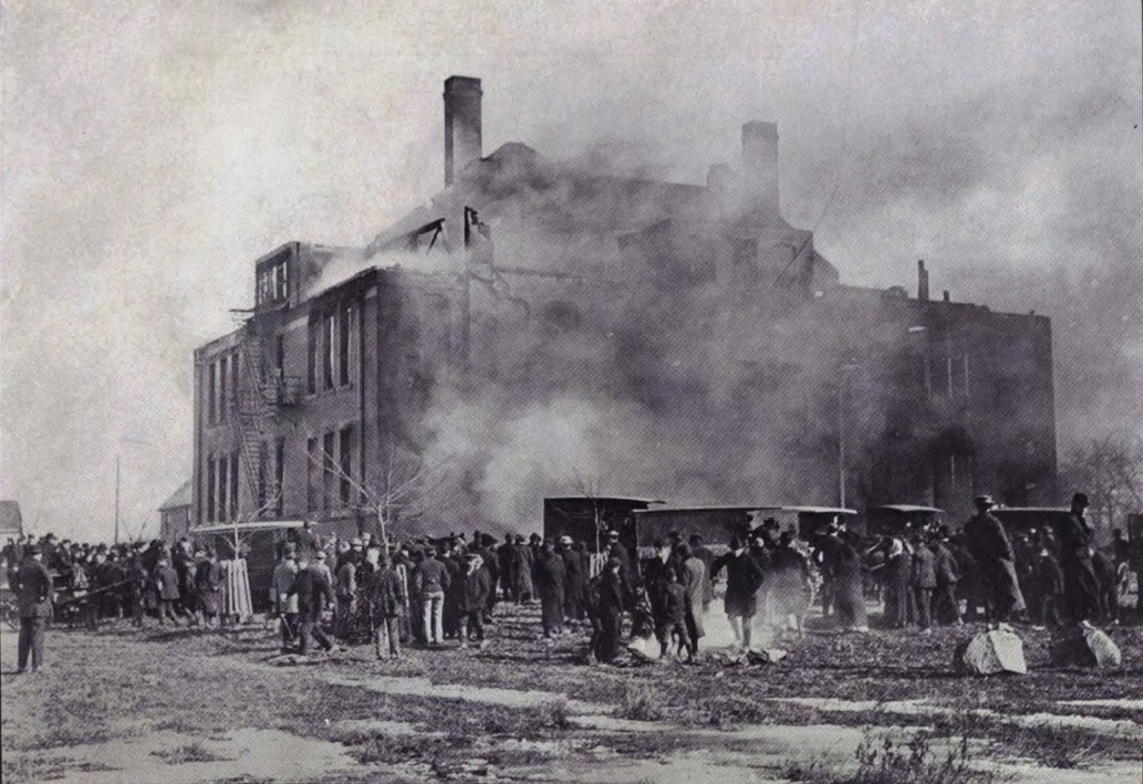 Crowds gathered around the smoldering shell of the school in Collinwood in 1908. 