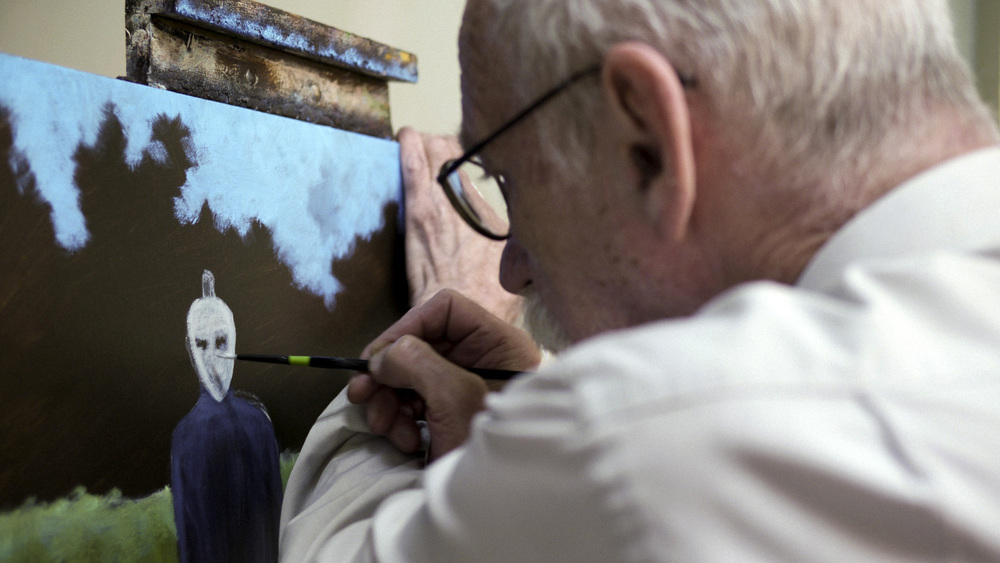 David Huggins at work on a painting from his abduction memories. (Brad Abrahams)